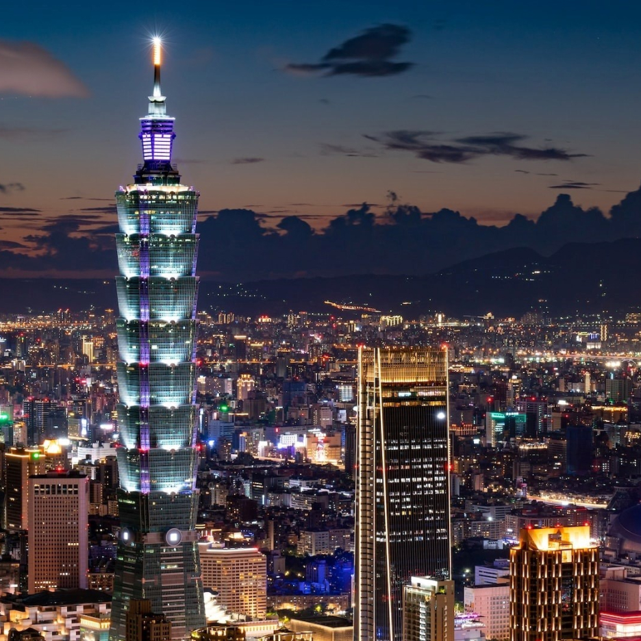 Taipei 101 skyscraper illuminated at night, towering over the city skyline
